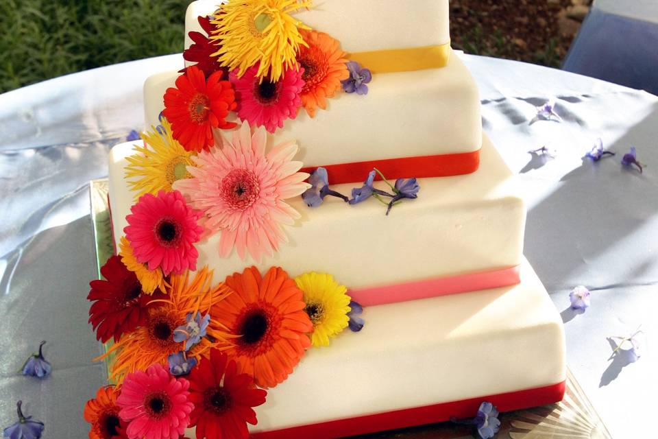 White wedding cake with summer flowers