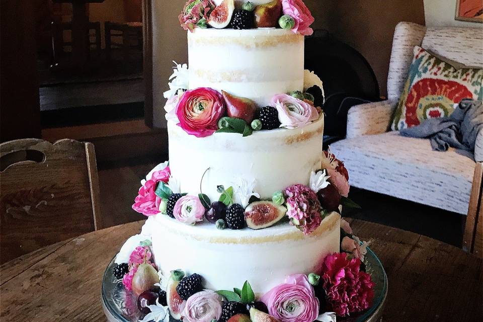 White wedding cake with pink tone flowers
