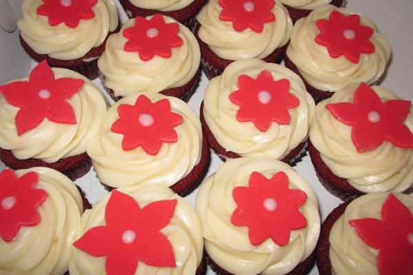 Red Velvet cupcakes topped with fondant red flowers.