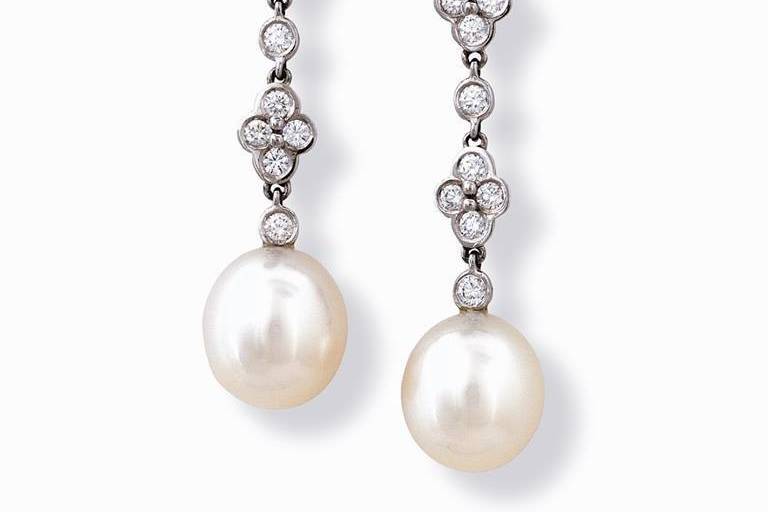 Delicate pearls suspended gracefully in 18k white gold and diamonds