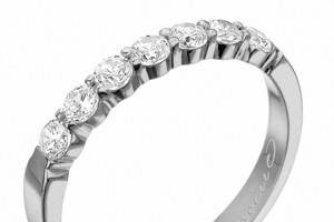 Round brilliant cut diamonds go 1/3 of the way around this wedding band, in 18k white gold or platinum