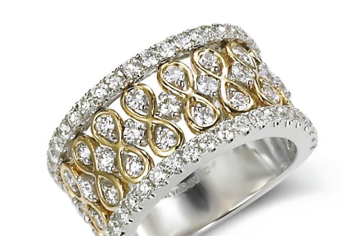 Wedding band in 18k white and yellow gold. Pave set round diamonds go 3/4 of the way around this exquisite band, and round brilliant cut diamonds fill the open metal work inside the band.