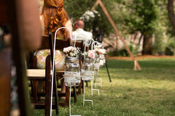 Wedding isle lined with delicate Colorado flowers leading to a river front ceremony