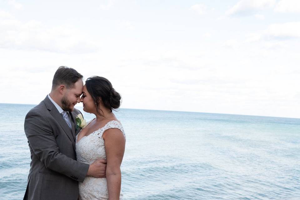 Bride and groom by water