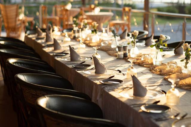 Long table dinner by the river at sunset