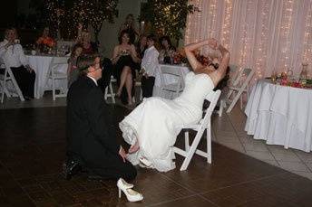 Groom taking off the garter from his lovely bride.