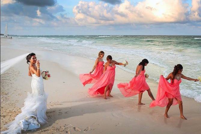 The bride and her bridesmaids by the shore