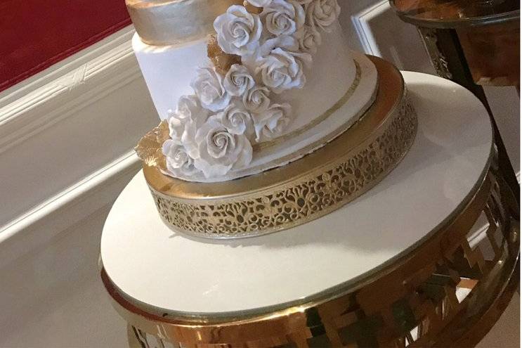 White and gold wedding cake.