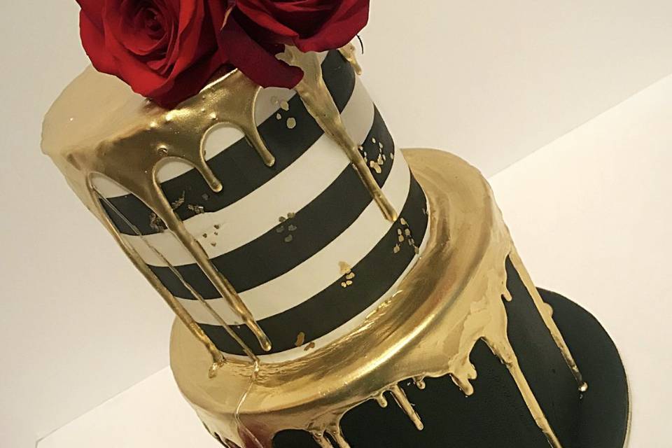 Red, black and gold drip cake.