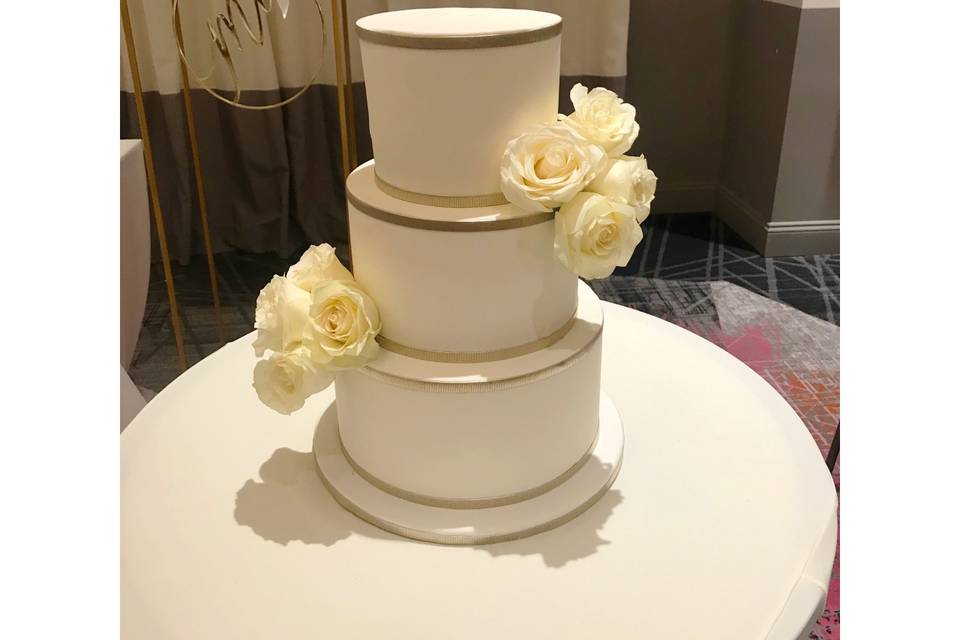 White and gold wedding cake.