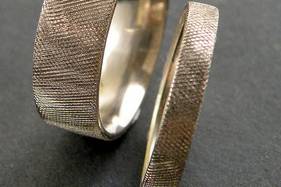Florentine finish wedding bands.  Shown here are a 6mm wide flat band with comfort fit and a 4mm wide flat, comfort fit band.  Knurled texture makes is a great choice as a wedding band for men.