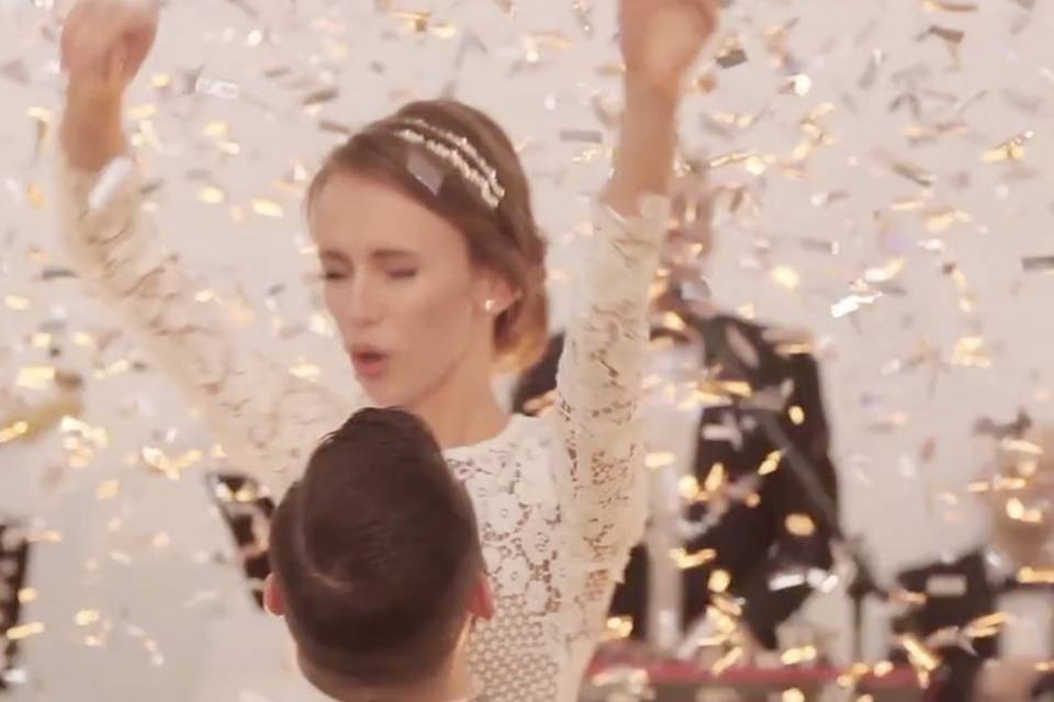 Newlyweds under confetti shower