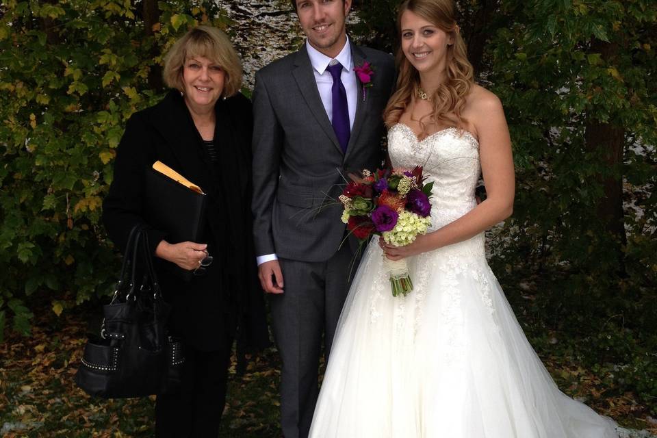 Groom and bride with their officiant