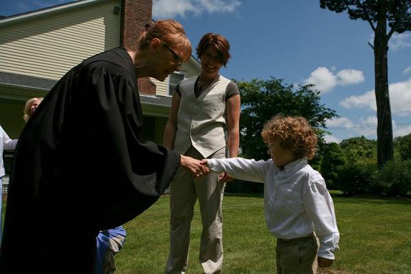 Officiant shaking hands with the child