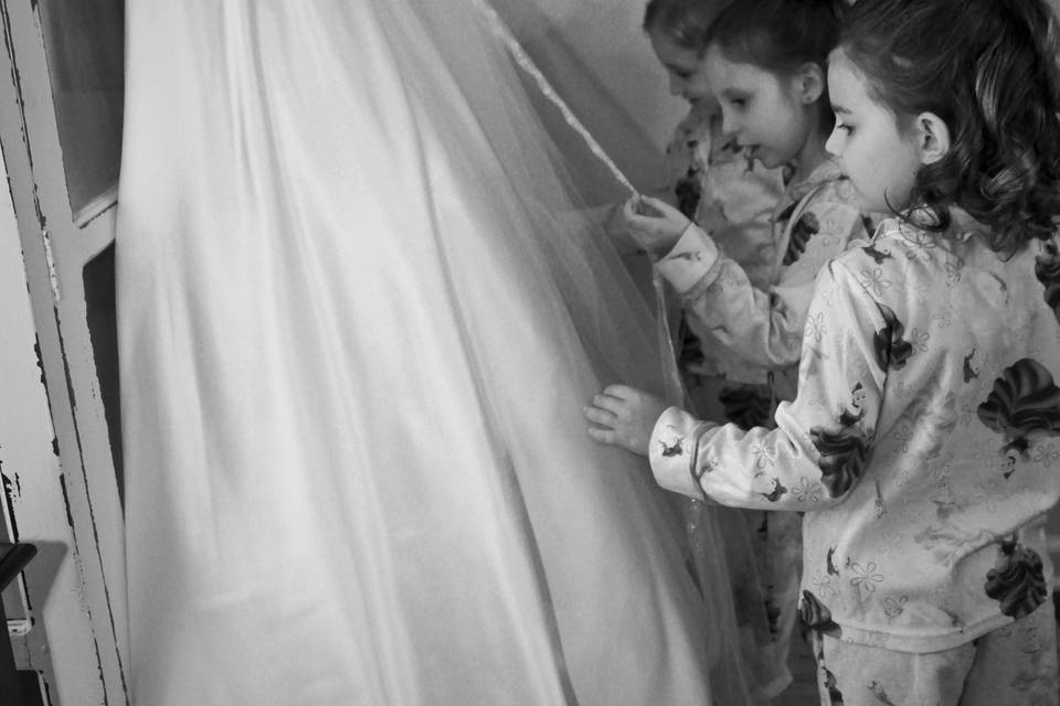 Kids touching the bridal dress