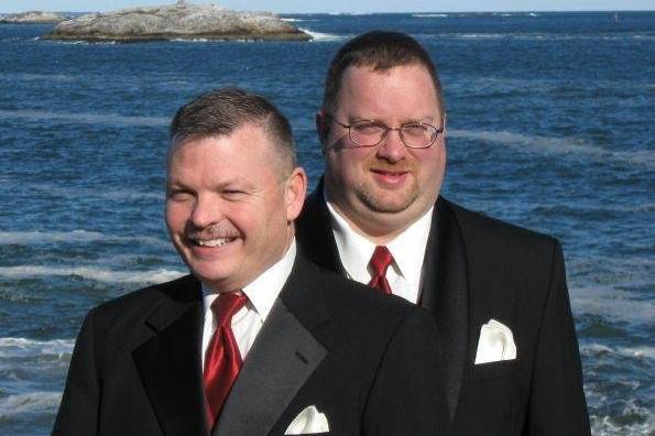 Bride and groom with the officiant