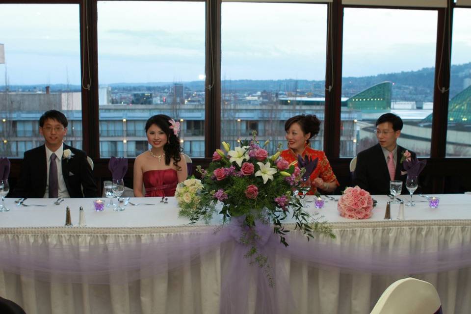 Head Table in front of windows.