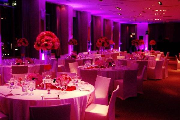 Tall and Short Floral Arrangement in Ballroom with Color Kinetic Uplighting.