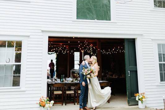 Newlyweds kissing by the entrance