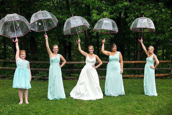 Bride and bridesmaids with umbrellas