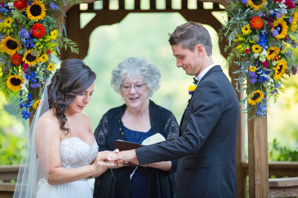 CT officiant Zita Christian guides the bride as she places the ring on her groom's finger | Photo by Tiny Humans