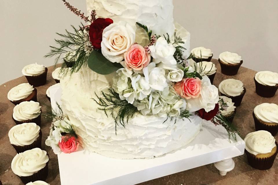 Wedding cake and cupcakes with white flowers