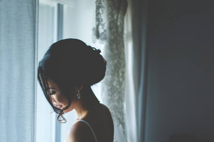 Bride looking out of a window