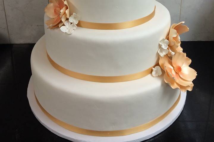 Five tier monogrammed wedding cake. Handmade magnolia and hydrangea arrangements.