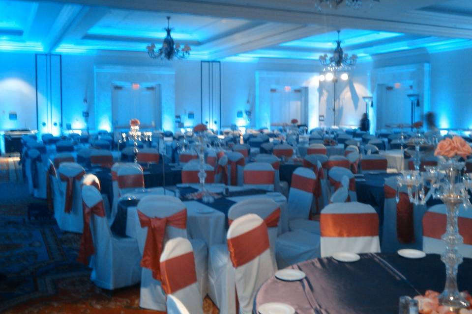 Blue reception lighting and orange chair bands