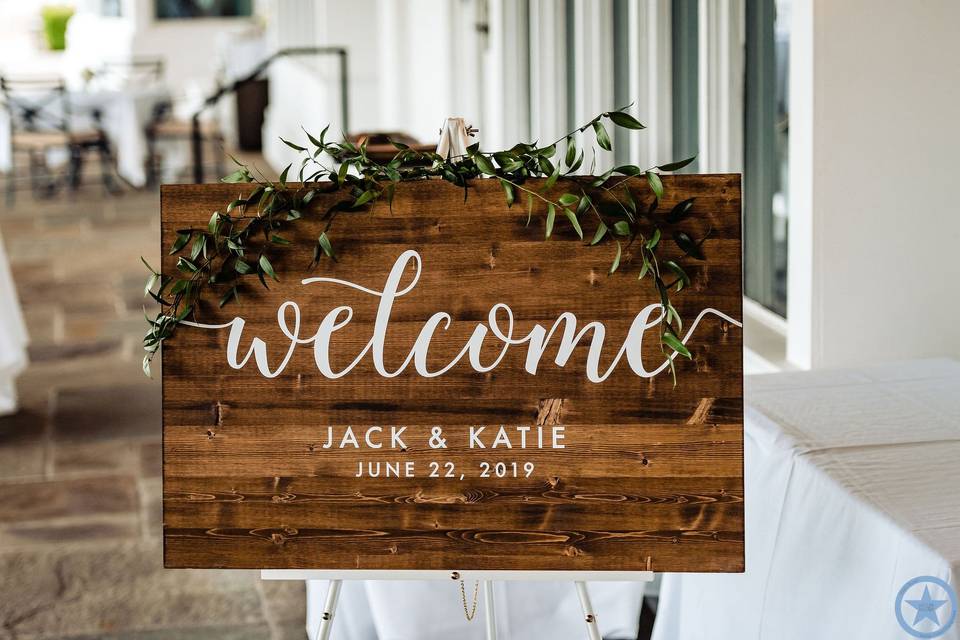 Greenery adorned welcome sign