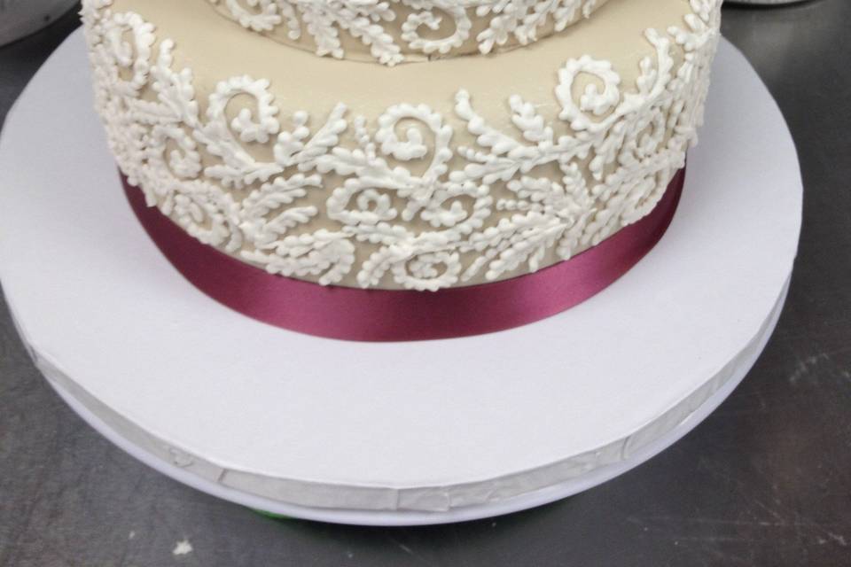 Beige cake with pink ribbon band