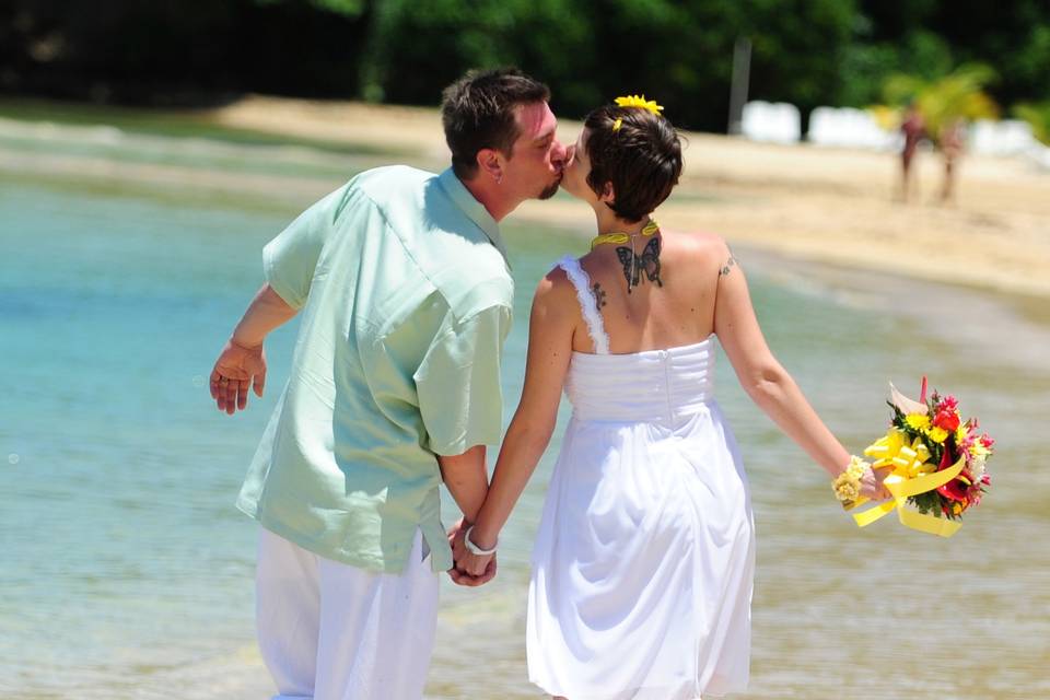 Beach destination wedding kiss