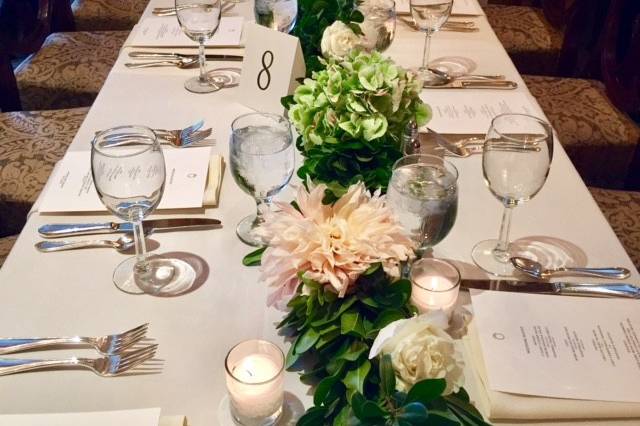 Table setting and wedding garland with flowers