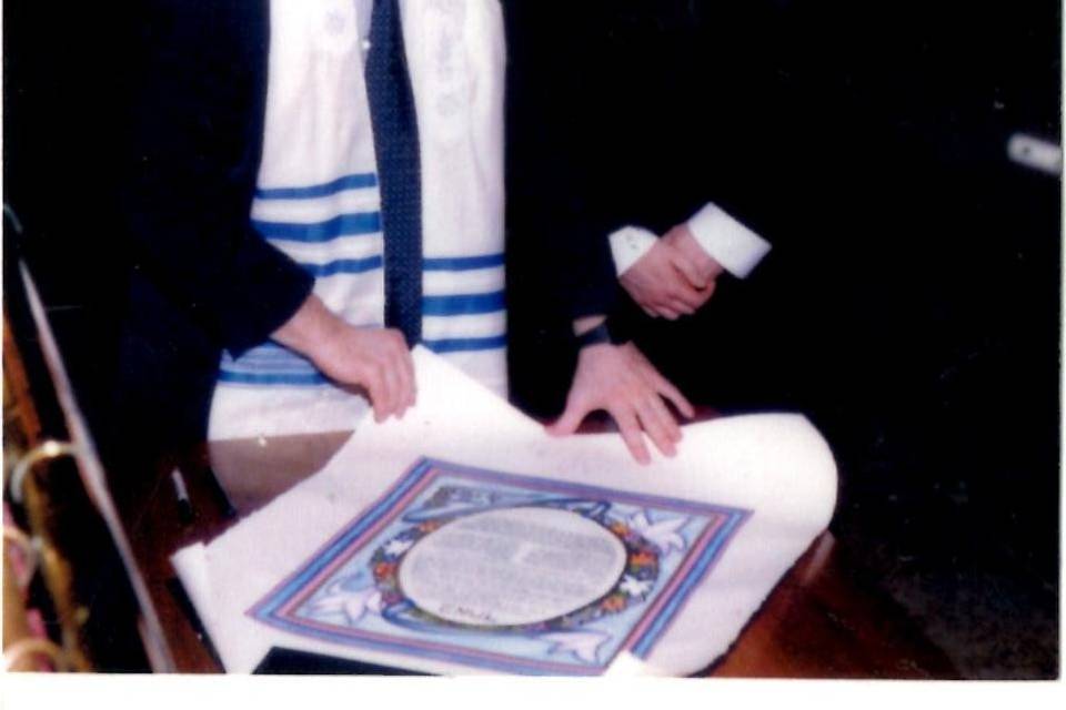 Reading ketubah to groom.