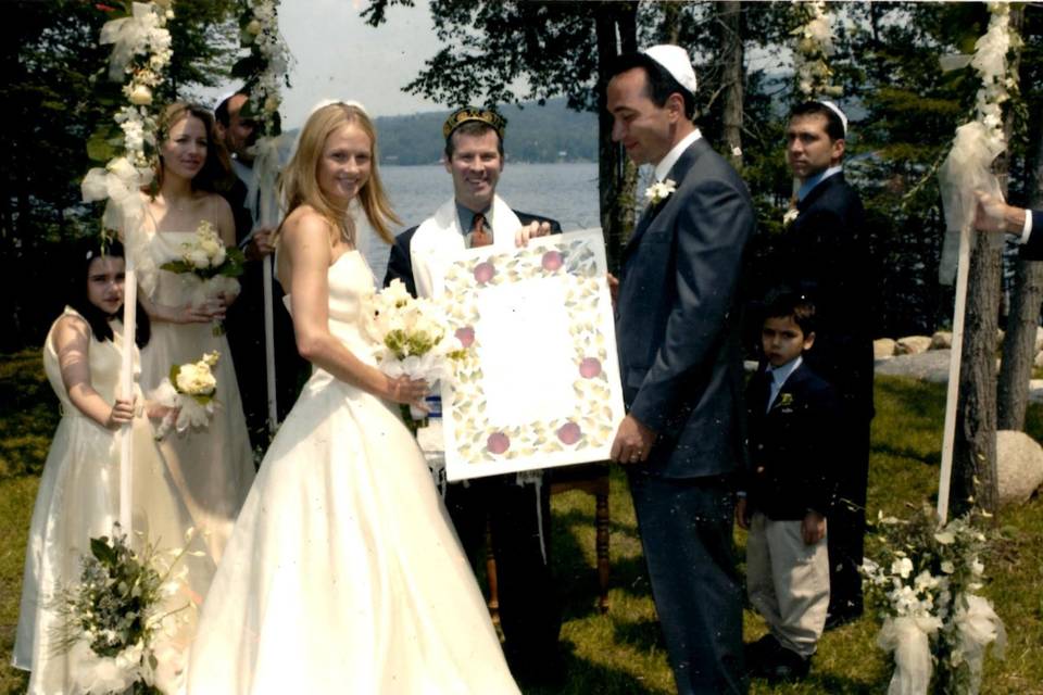 Reading ketubah to groom and his mother.