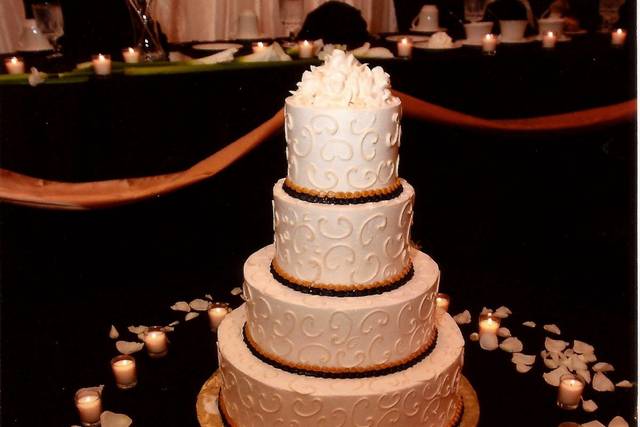 Cake surrounded by candles and petals