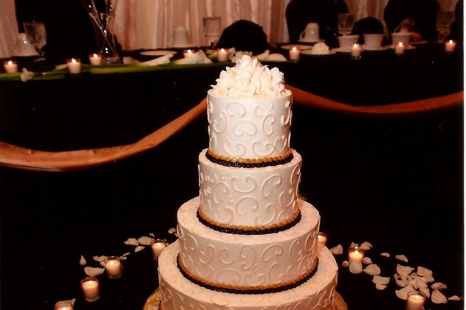 Cake surrounded by candles and petals