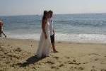 Bride and Groom Walk The Beach