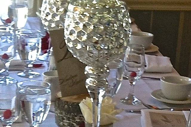 Banquet Style tables for coworker firemen. Mercury goblets votives, red roses and peddles