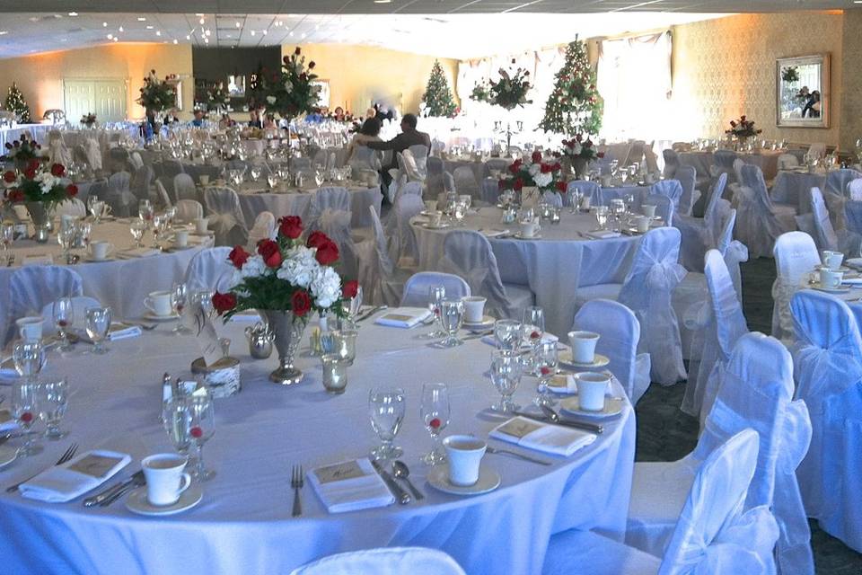 Just after Thanksgiving, 9ft Christmas trees installed with white lights. 3 types of centerpieces for this 280 person reception.