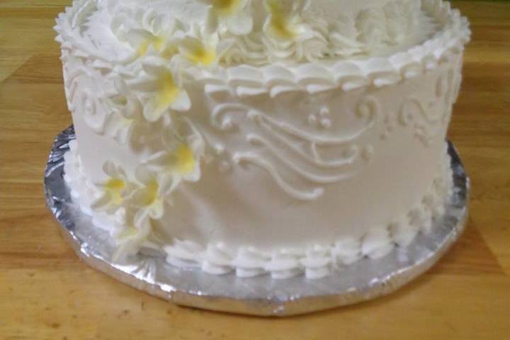 Two tier wedding cake with yellow flowers