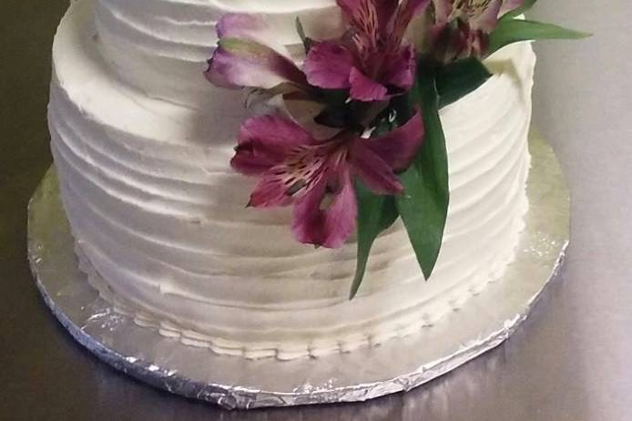 Two tier cake with purple flowers