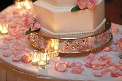 Four layered white cake with roses