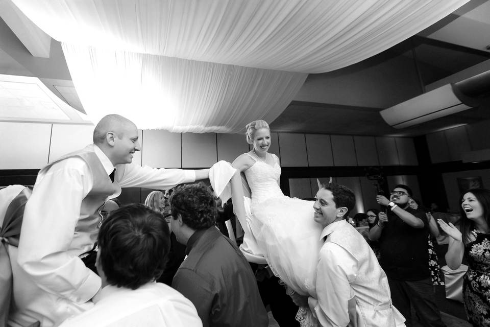 Couple and their guests dancing in black and white