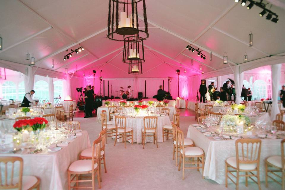 Elegant tented reception with iron chandeliers