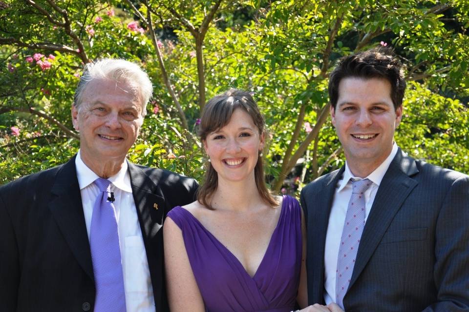 Bride and groom with their wedding officiant