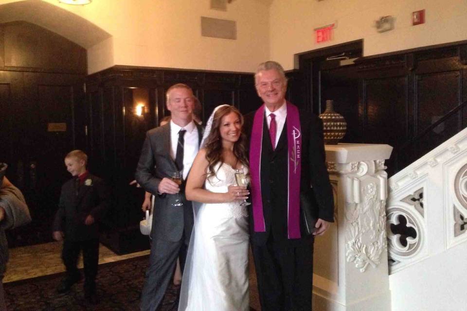 The reverend with the bride and groom