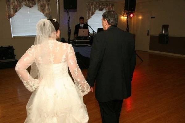 Bride & groom walking towards dj billy zee for their 1st dance.