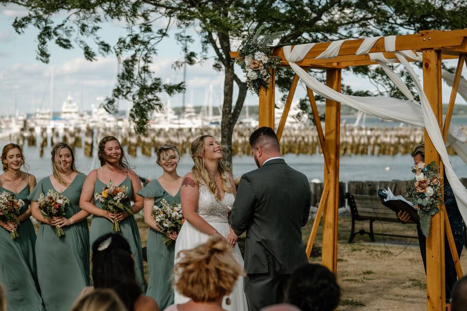 Bride laughs during beach vows