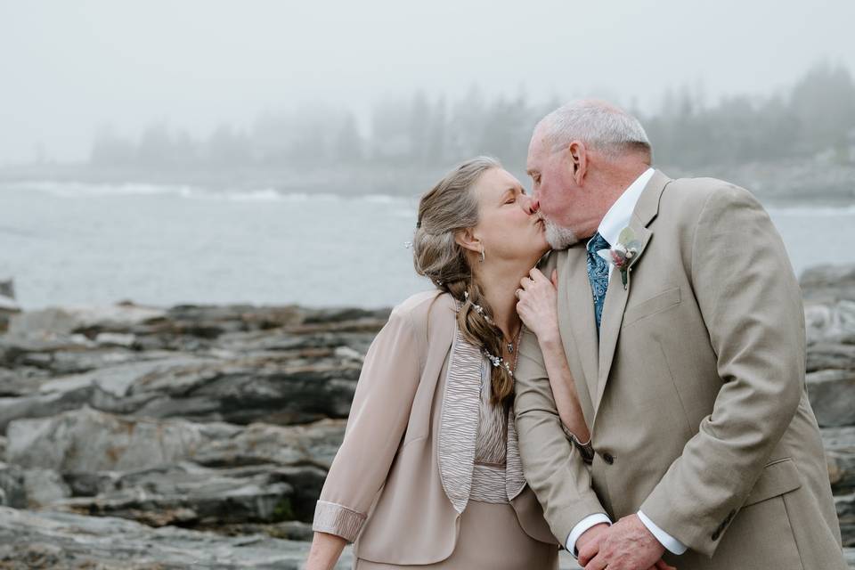 Mature couple kiss on beach